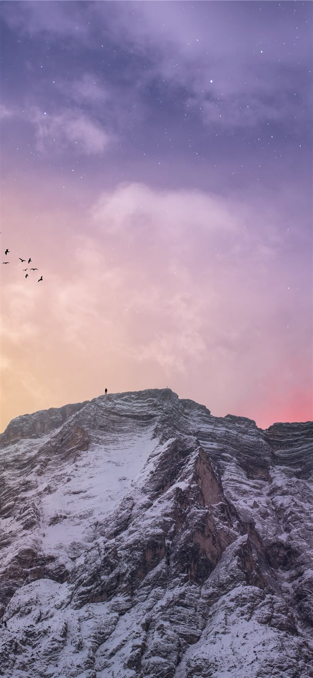 mountain covered with snow under blue and orange s... iPhone X wallpaper 