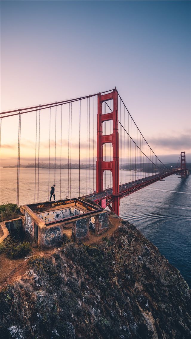 person walking on Golden Gate bridge iPhone 8 wallpaper 