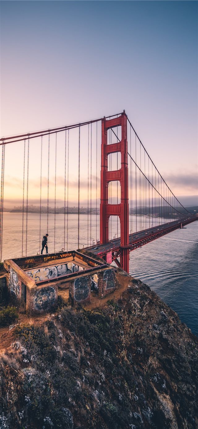 person walking on Golden Gate bridge iPhone X wallpaper 