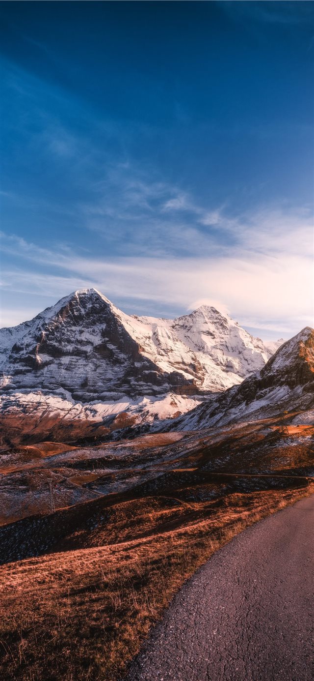 roadway beside iced capped mountain during daytime iPhone X wallpaper 
