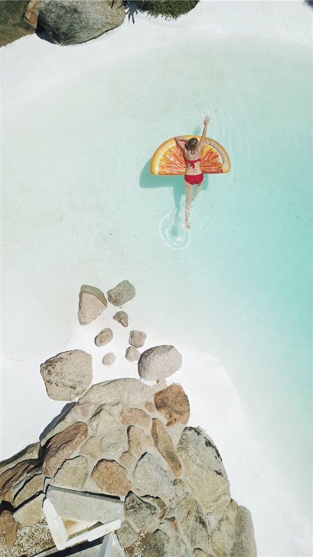 woman on swim ring iPhone 8 wallpaper 