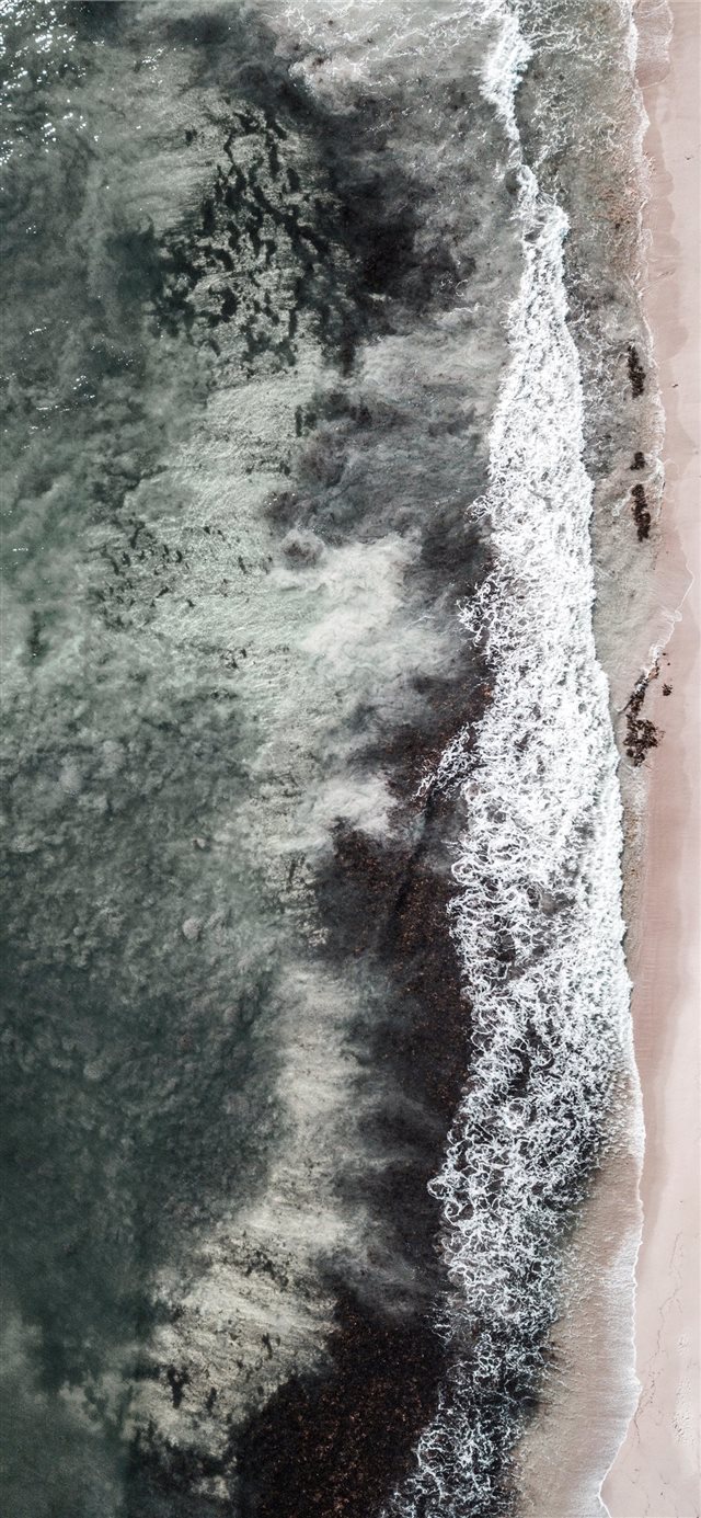 aerial view of crashing waves iPhone X wallpaper 