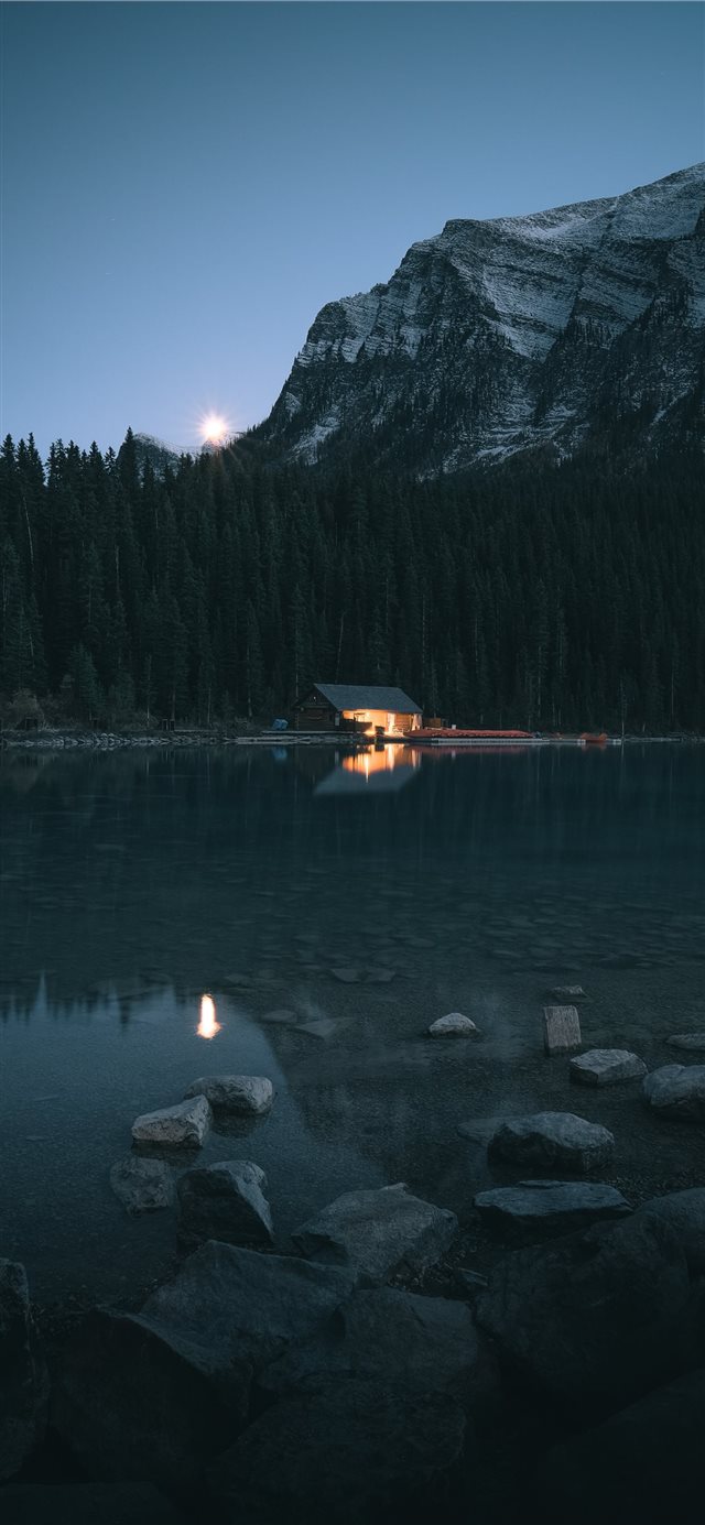 cabin beside lake and trees iPhone X wallpaper 