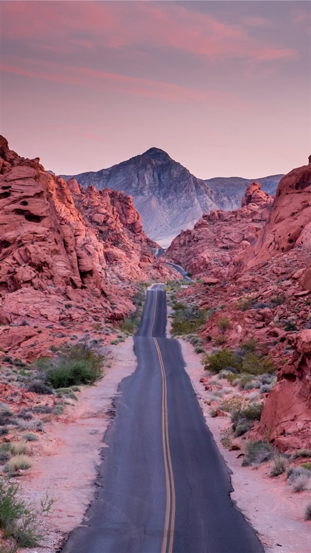 photo of empty road between rock formations iPhone 8 wallpaper 
