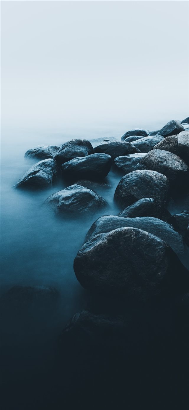 rocks near body of water iPhone X wallpaper 