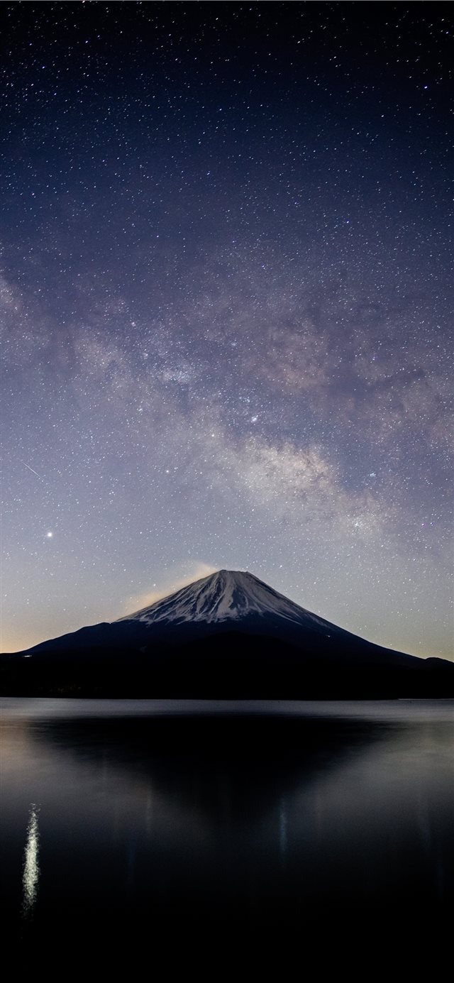 snow covered mountain near lake under starry night iPhone X wallpaper 