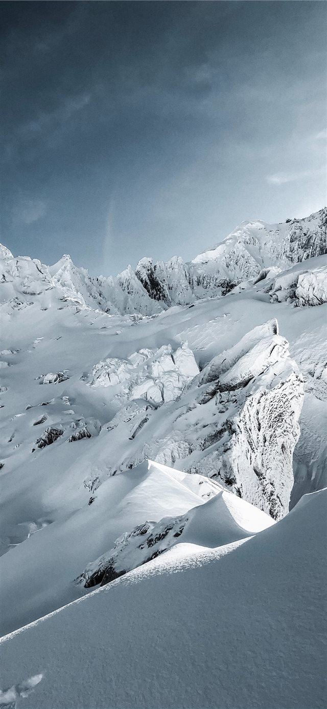 snow covered mountain under blue sky during daytim... iPhone X wallpaper 