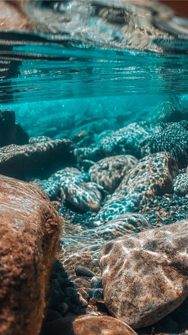 underwater photography of brown stones iPhone 8 wallpaper 