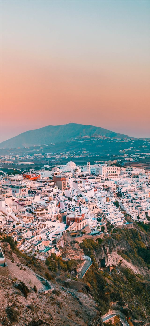 city buildings on mountain during daytime iPhone X wallpaper 