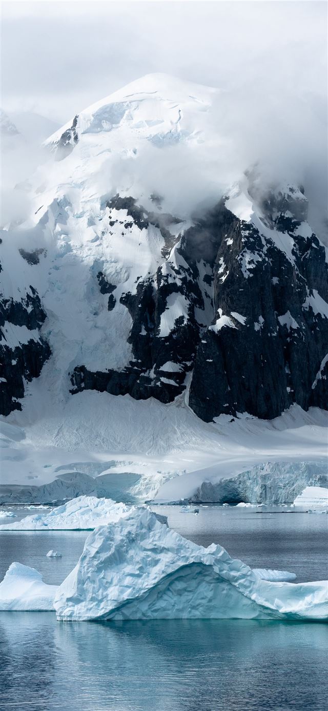 small iceberg beside large iceberg iPhone X wallpaper 