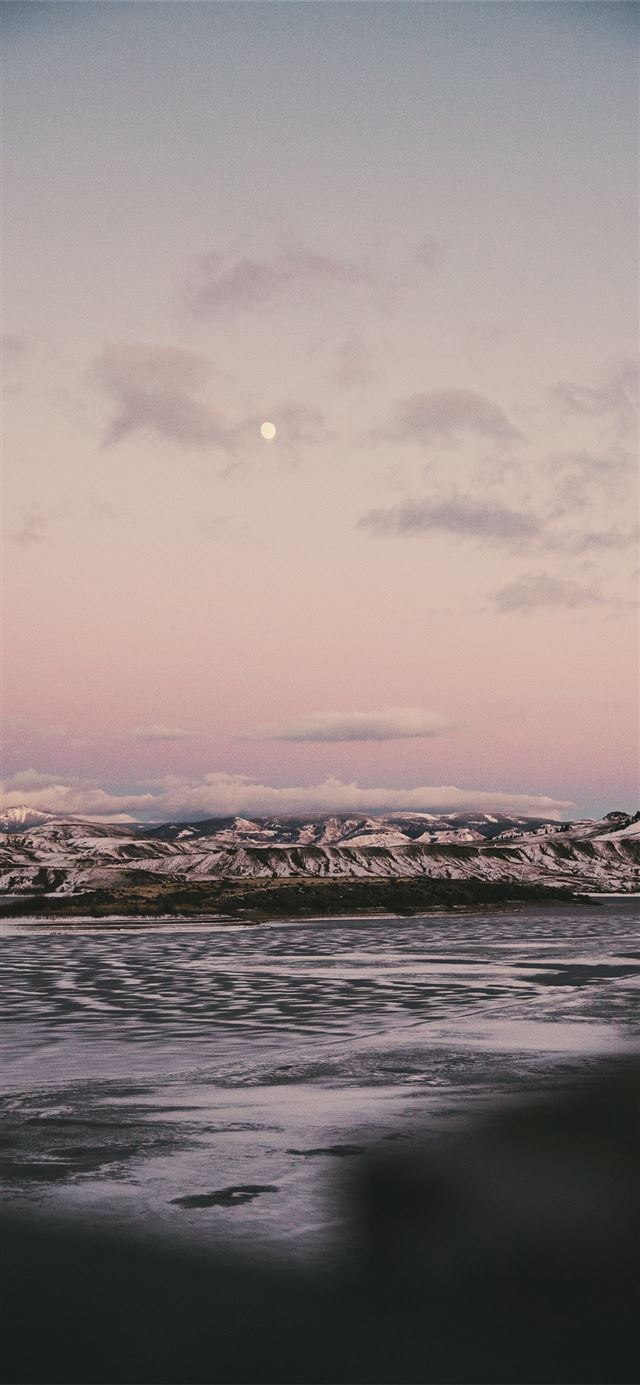 grayscale photo of body of water and rocks iPhone X wallpaper 