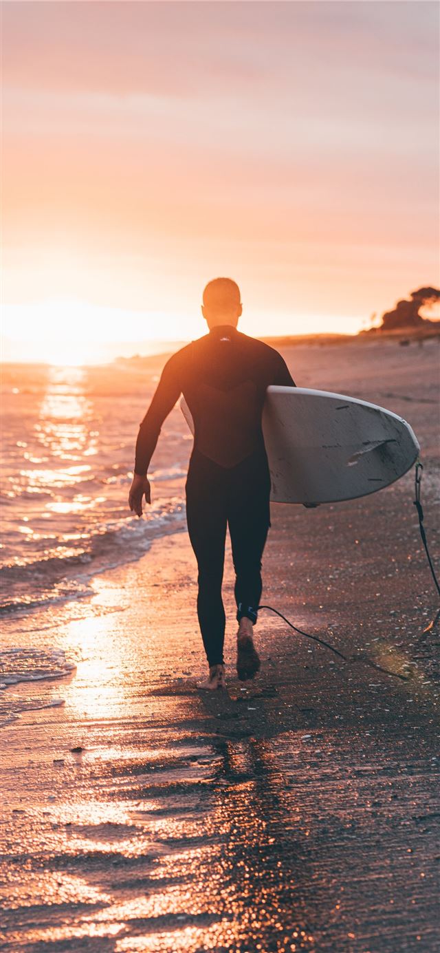 man holding white surfboard iPhone X wallpaper 