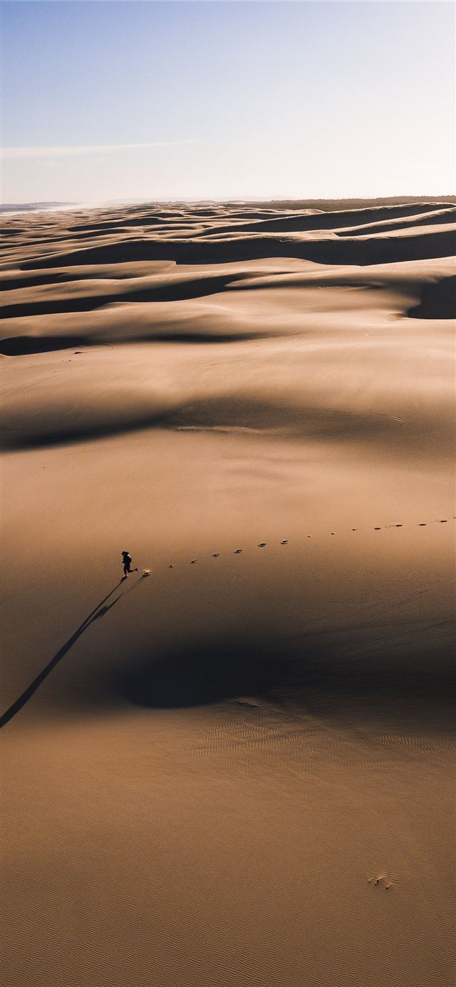 person walking on the desert photography iPhone 11 wallpaper 