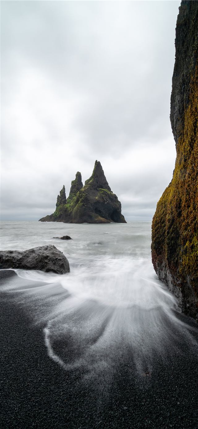 time lapse of shore near rock formation at daytime iPhone 11 wallpaper 