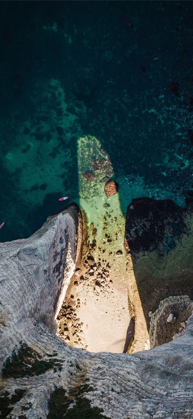 top view photo of seashore near blue body of water iPhone X wallpaper 