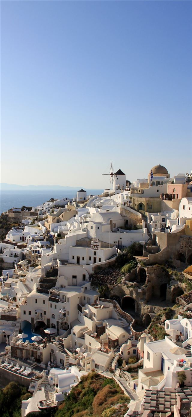 white painted mediterranean houses on a slope on s... iPhone X wallpaper 