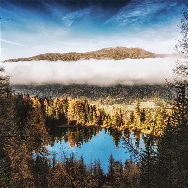 pine trees beside water body mountains clouds 4k iPad Pro wallpaper 