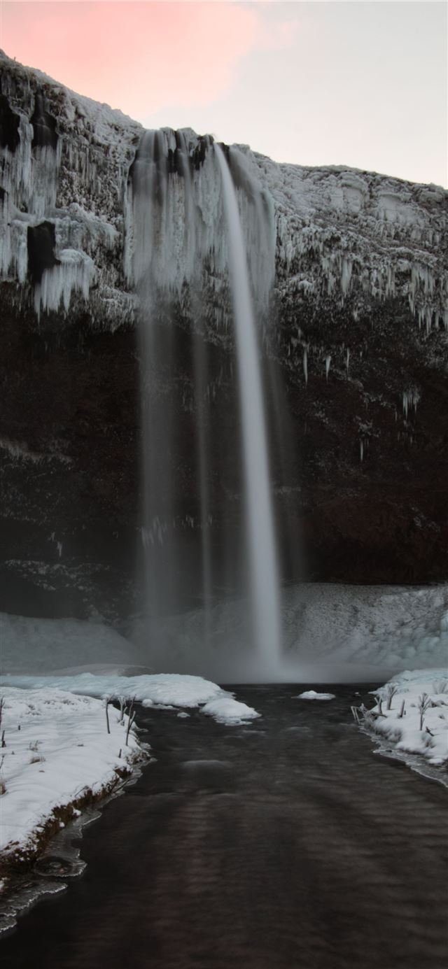 water falls on snow covered ground iPhone X wallpaper 