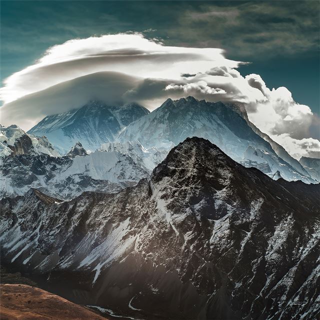 mountains covered in snow clouds 4k iPad Air wallpaper 