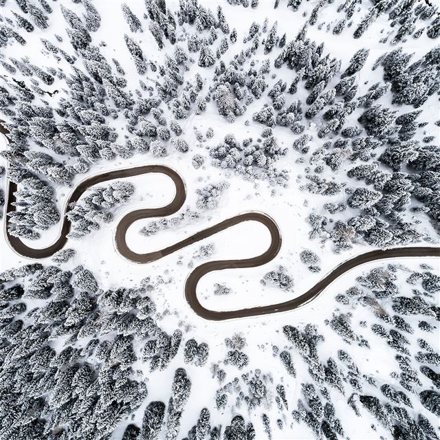 road between snowy forest 4k iPad wallpaper 