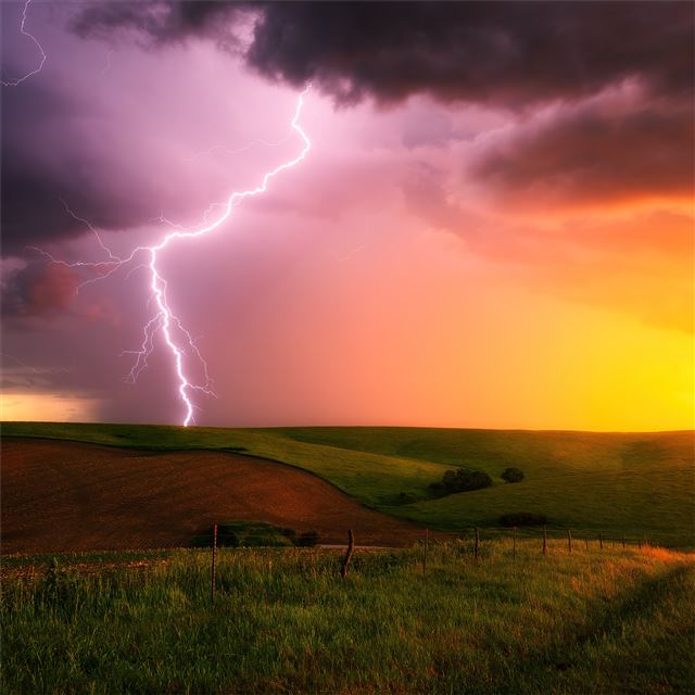 thunderstorm lightning bolt striking down at sunse... iPad wallpaper 