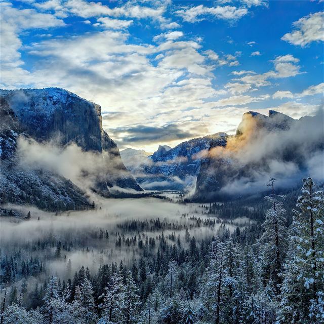 fog and clouds over snowy winter mountain 4k iPad wallpaper 