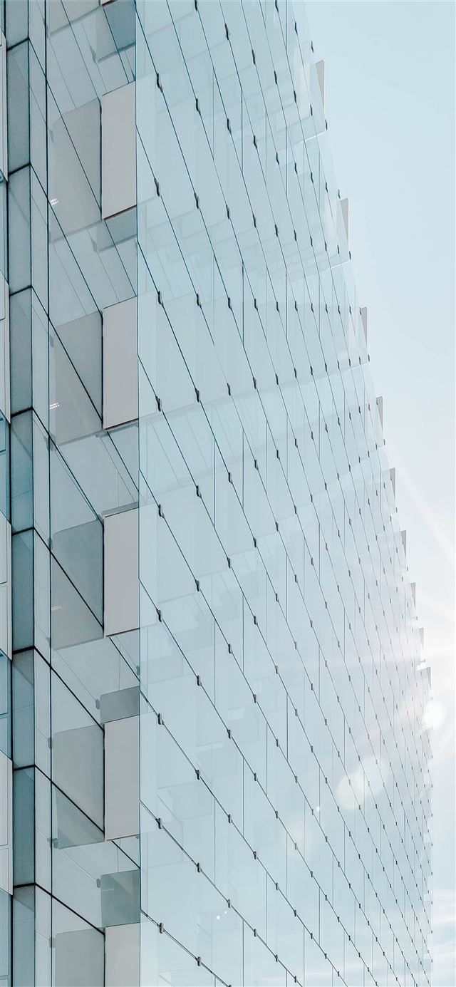 glass panel high rise building under blue sky with... iPhone 11 wallpaper 