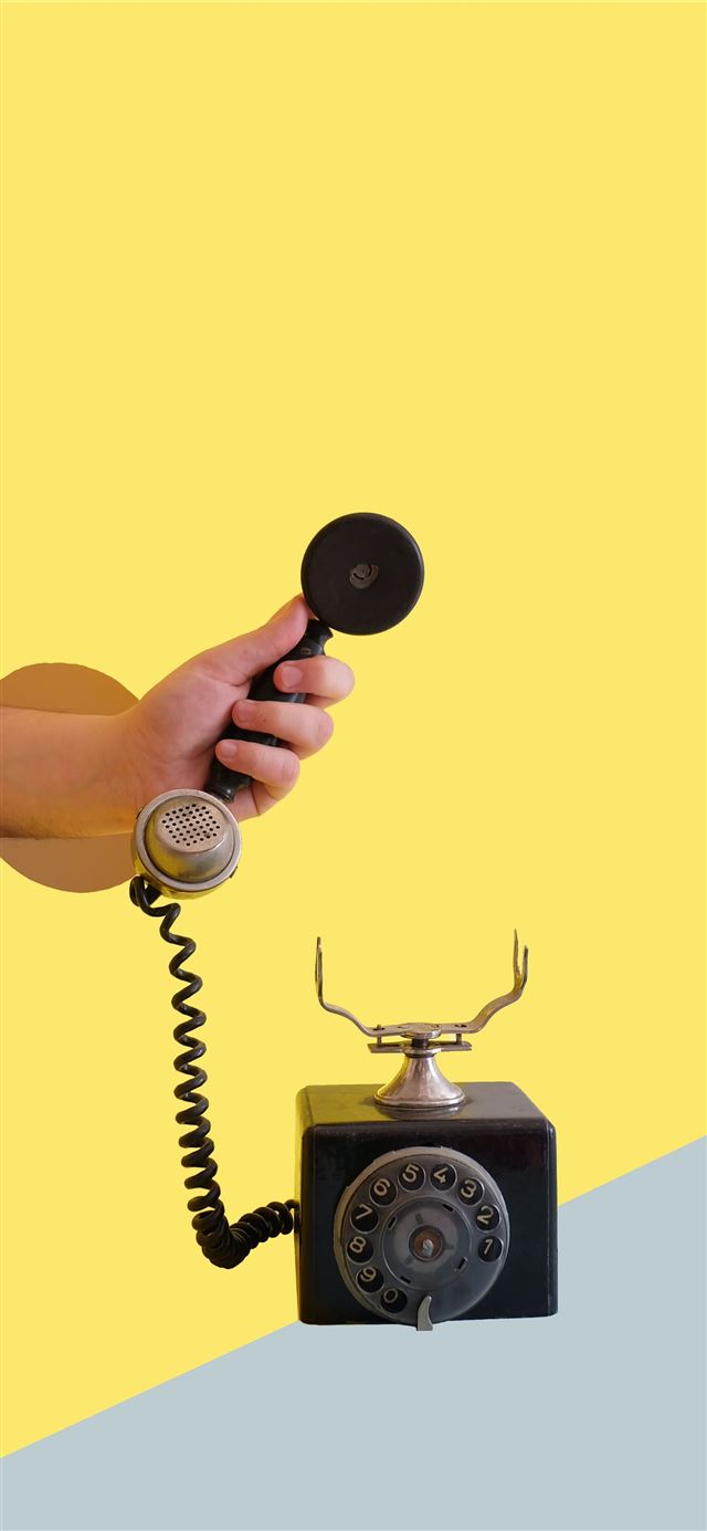 person holding black rotary telephone iPhone 11 wallpaper 
