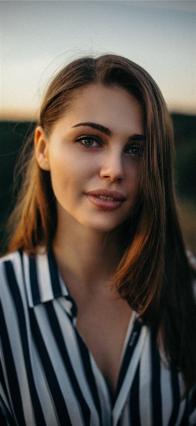 smiling woman wearing white and black pinstriped c... iPhone 8 wallpaper 