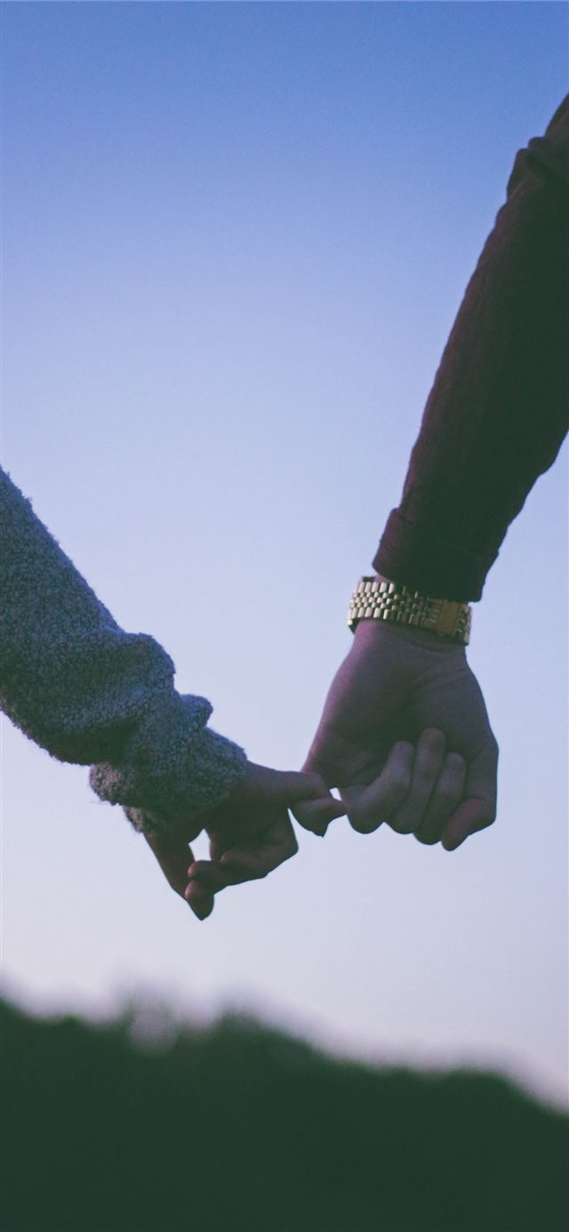 man and woman holding hand using pinky fingers iPhone 11 wallpaper 
