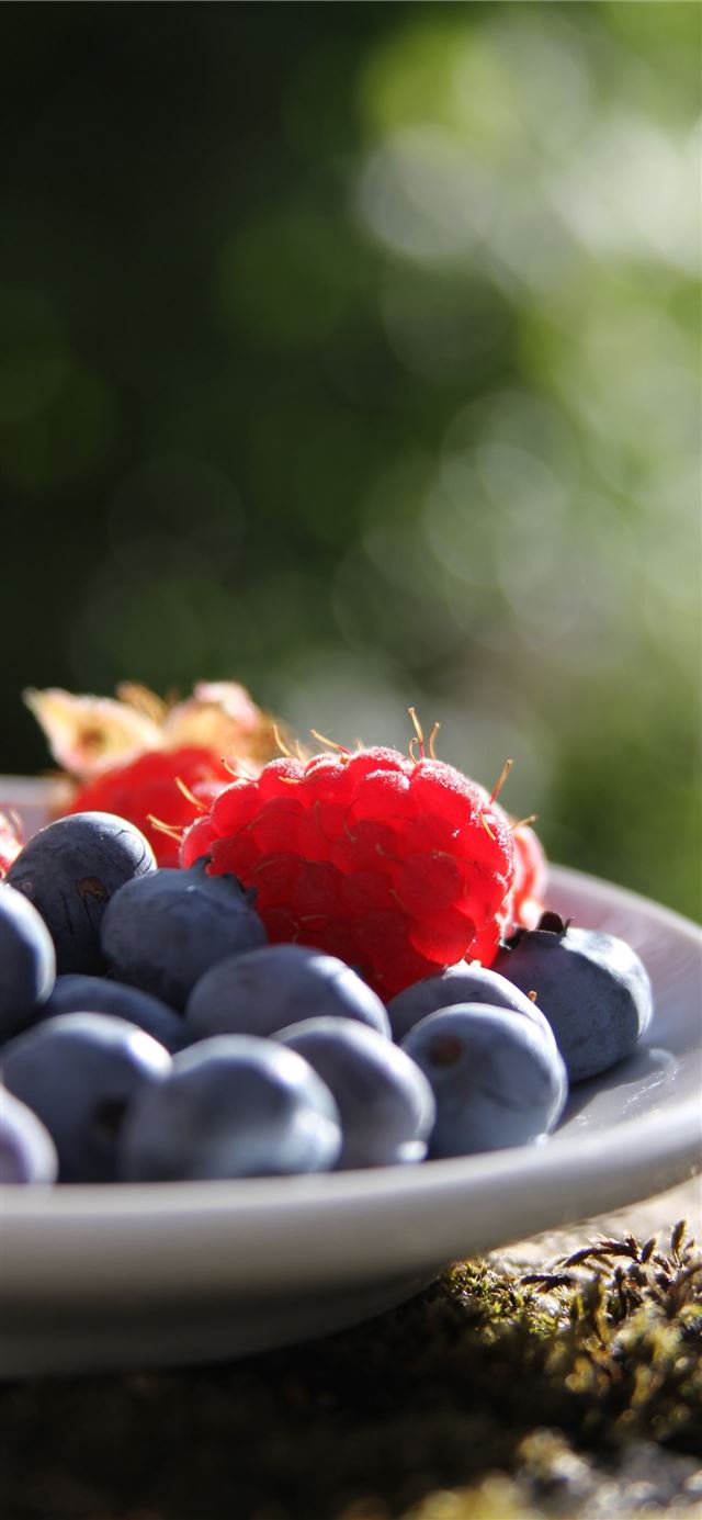 selective focus of blueberries and raspberries on ... iPhone 11 wallpaper 