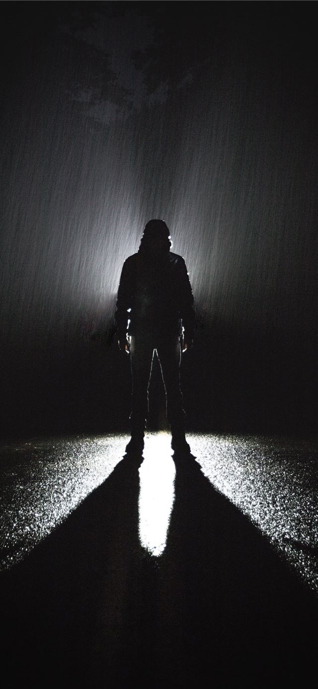 silhouette of person standing on road during rain iPhone 11 wallpaper 