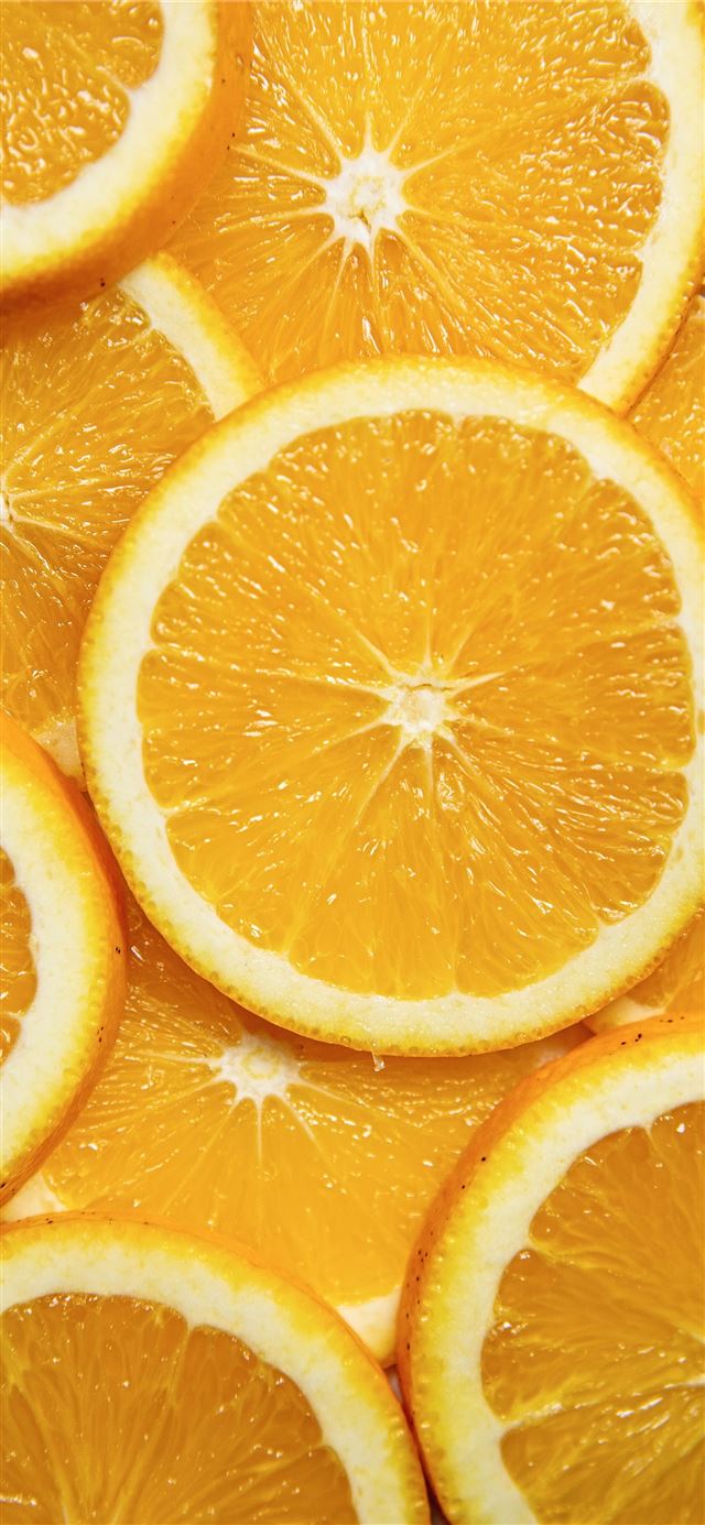 sliced orange fruit on white ceramic plate iPhone 11 wallpaper 