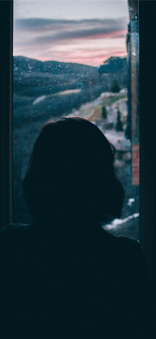 women's silhouette facing outside window iPhone 11 wallpaper 