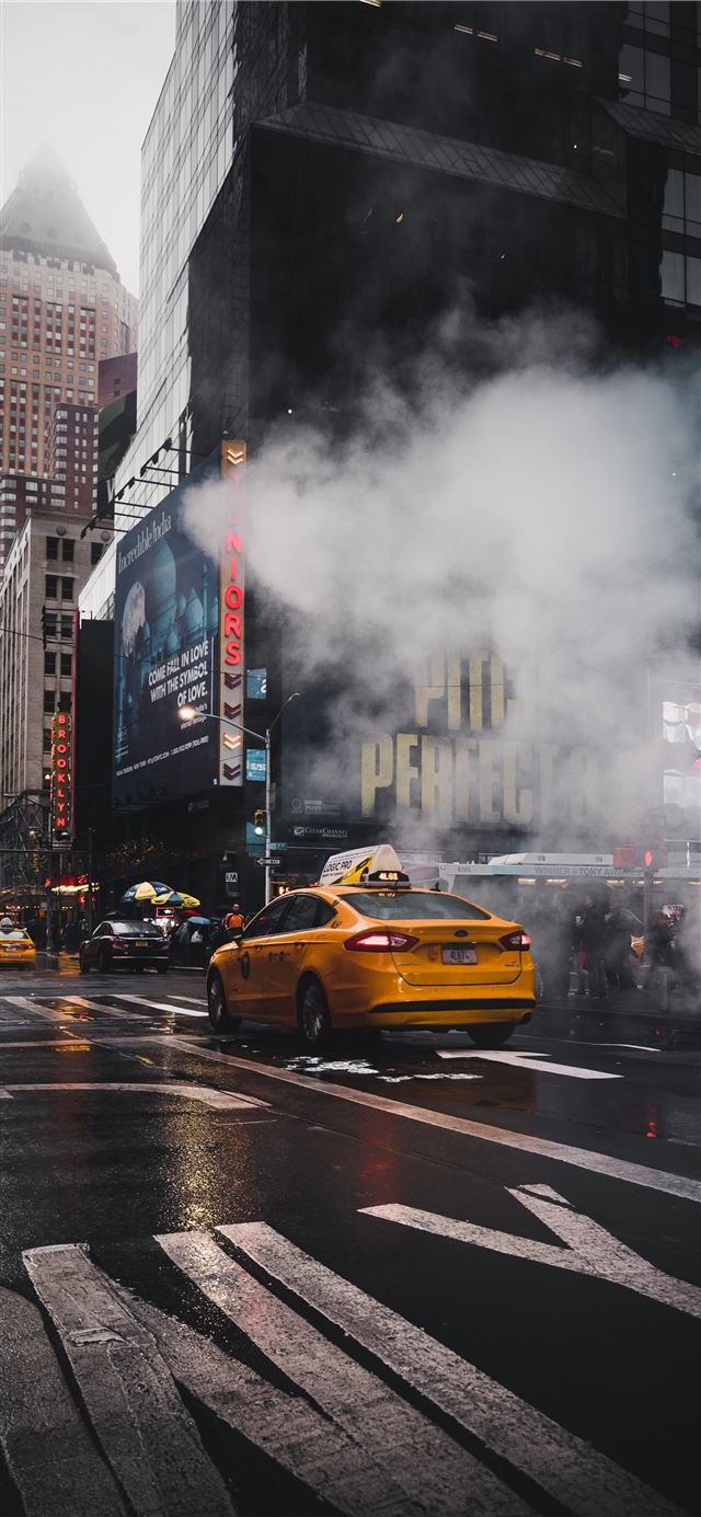 yellow taxi sedan on gray concrete street passed t... iPhone 8 wallpaper 