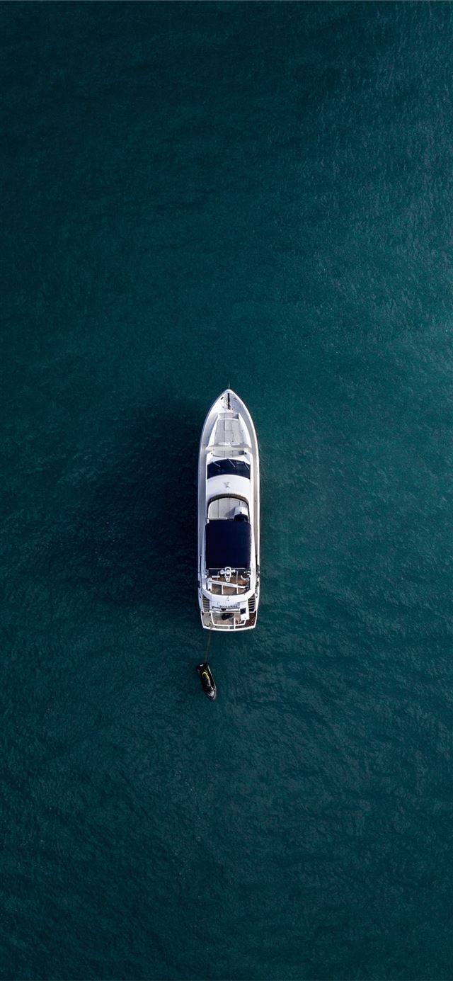 aerial photography of white yacht on calm waters iPhone 11 wallpaper 