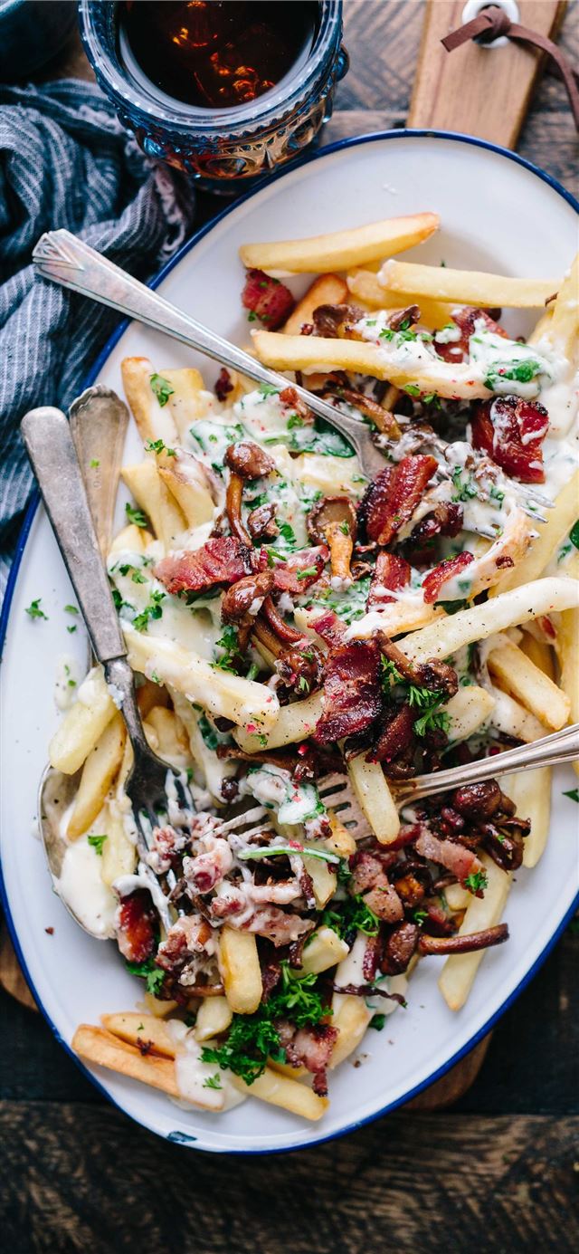 bacon strips and melted cheese topped fries on ova... iPhone 11 wallpaper 
