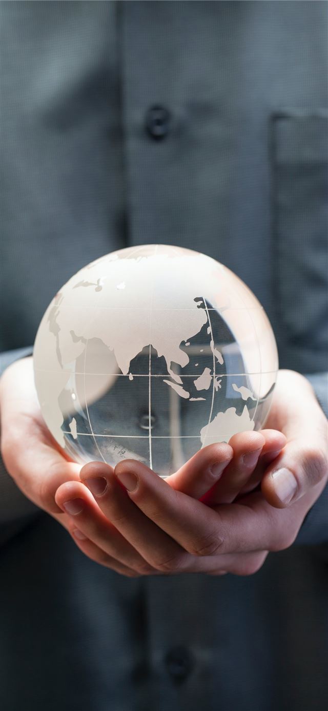shallow focus photo of clear glass globe table orn... iPhone 11 wallpaper 
