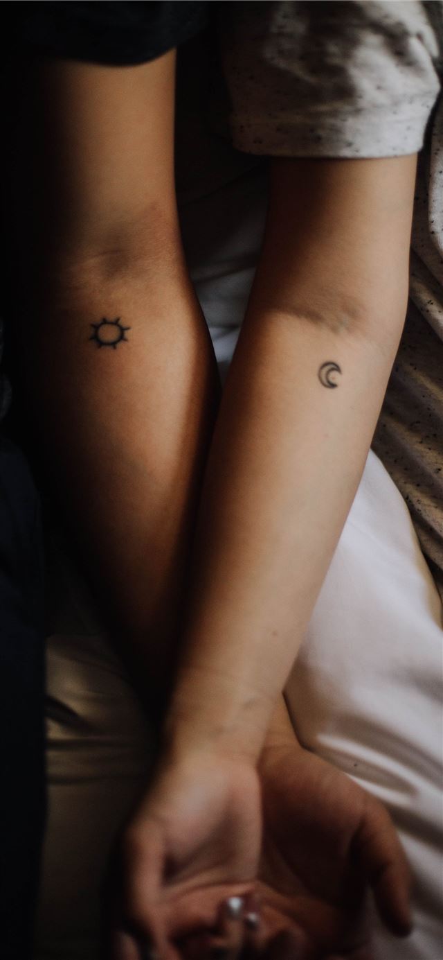 two persons showing their hand tattoos iPhone 11 wallpaper 