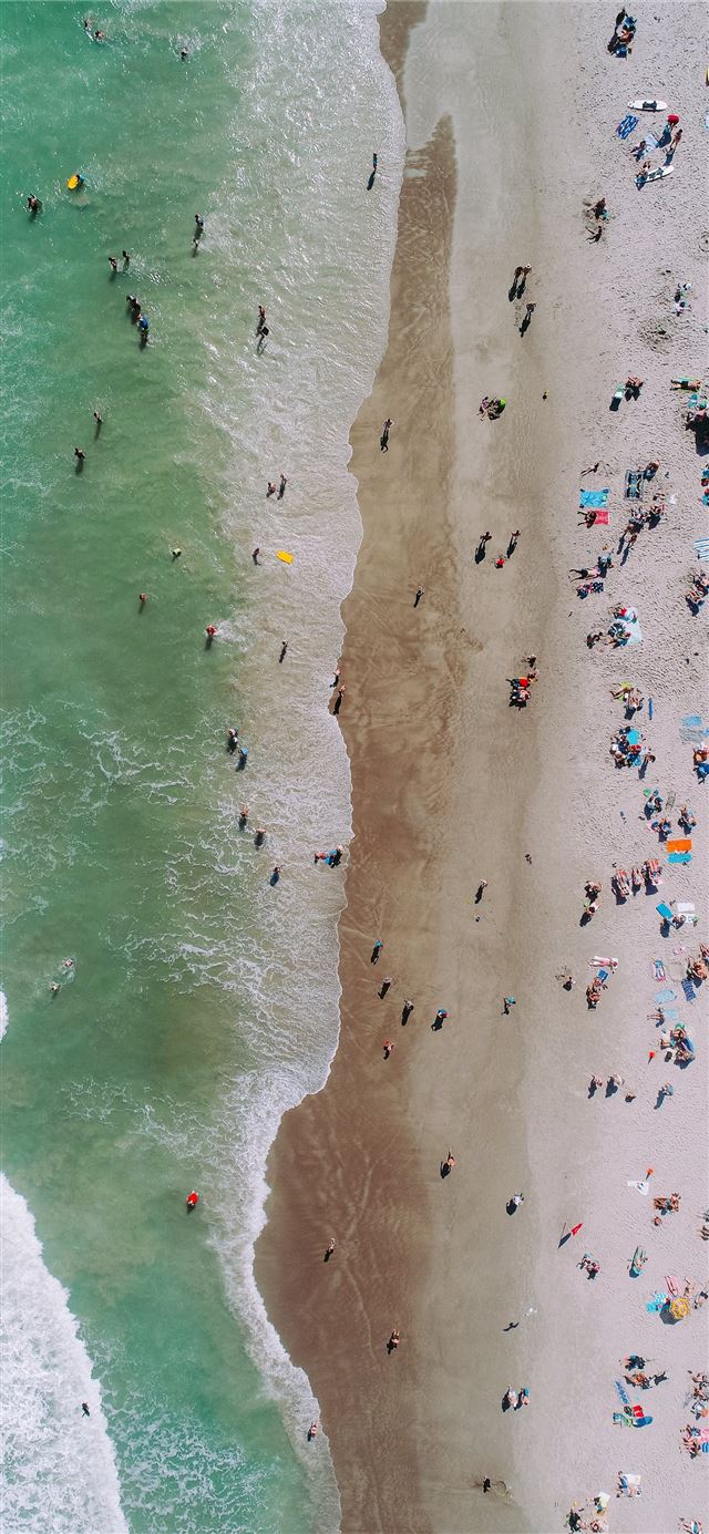 aerial photo of people on seashore during daytime ... iPhone 11 wallpaper 