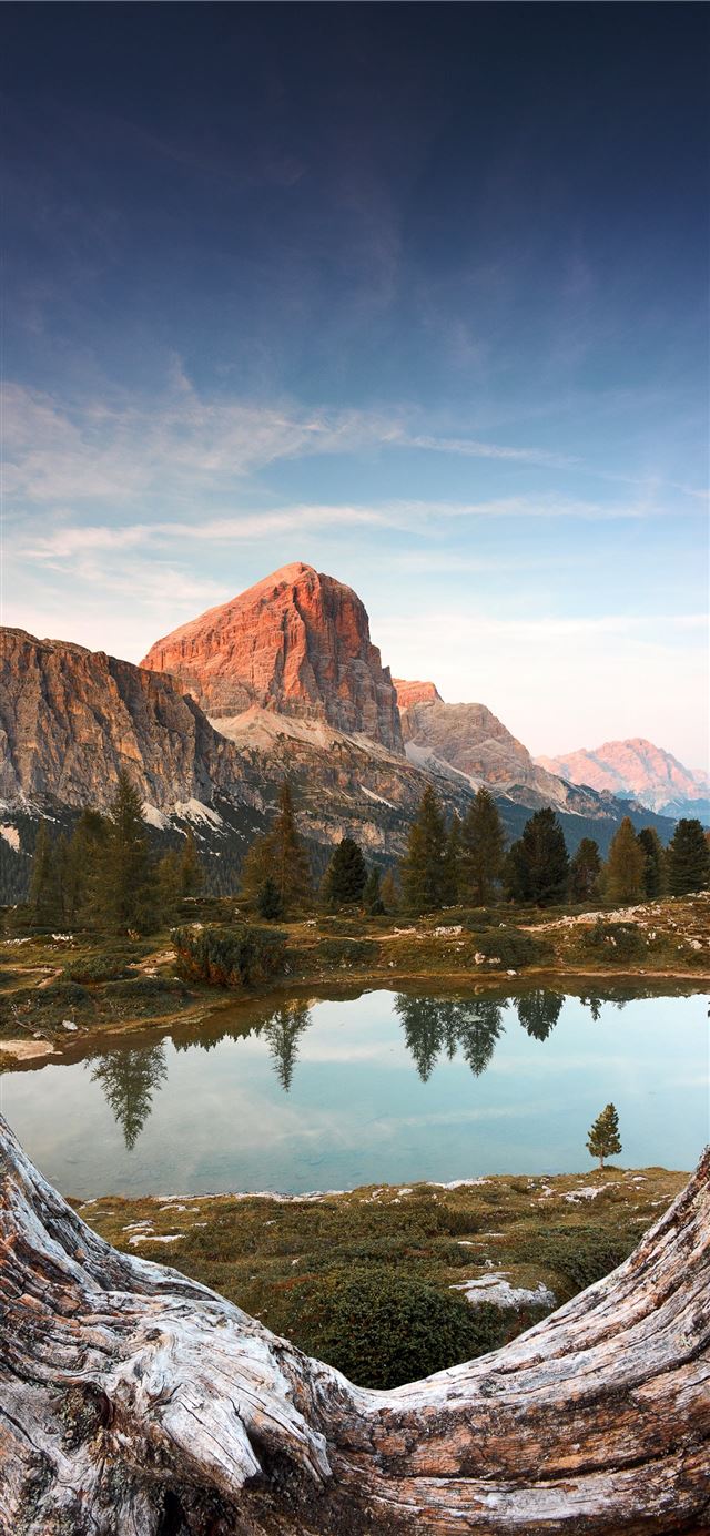 brown mountain near body of water during daytime iPhone 11 wallpaper 
