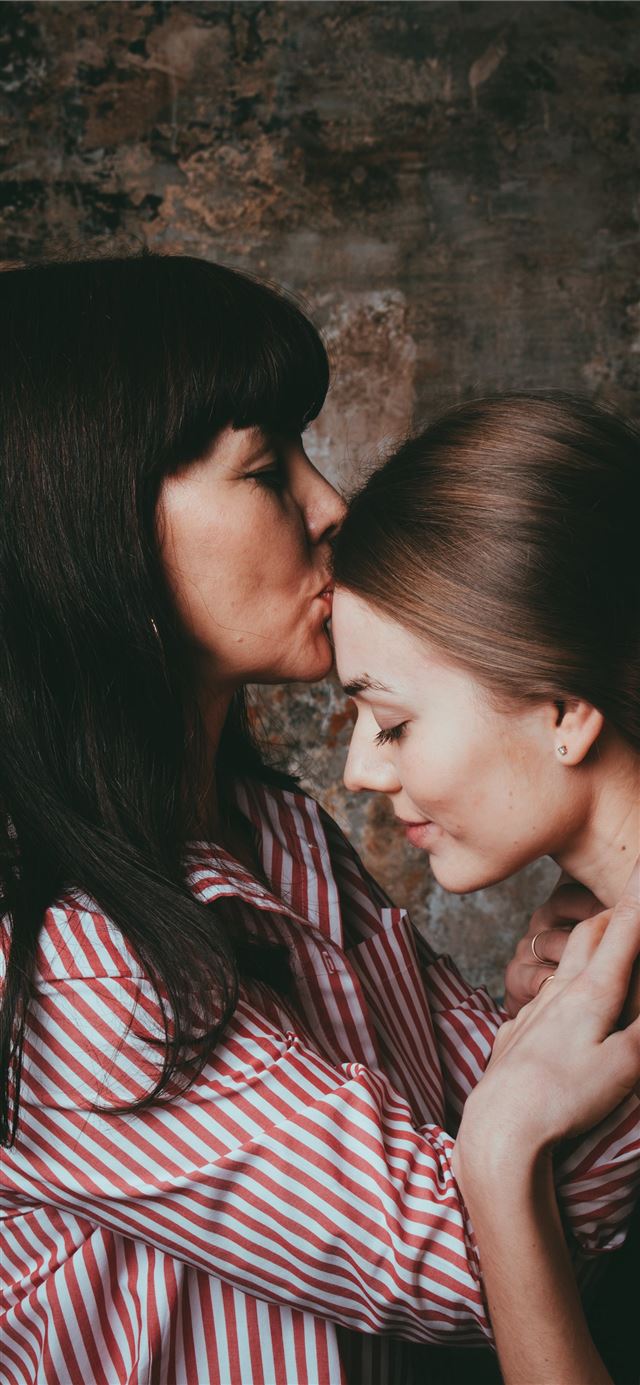 girl in pinstriped shirt kissing the woman's foreh... iPhone 11 wallpaper 