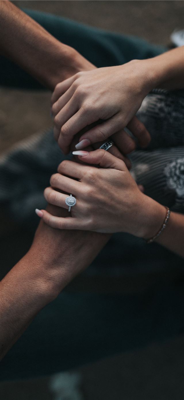 man and woman holding each others hands iPhone 11 wallpaper 
