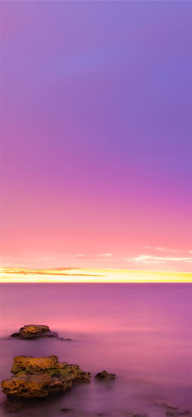 rock formation on body of water during sunrise iPhone 11 wallpaper 
