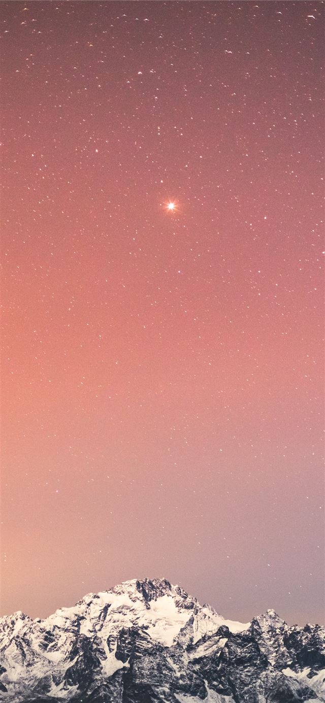 snow covered mountain under blue sky with stars du... iPhone 8 wallpaper 