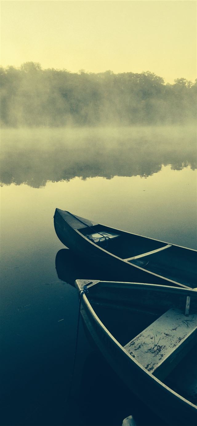 two gray canoes on misty body of water iPhone 11 wallpaper 