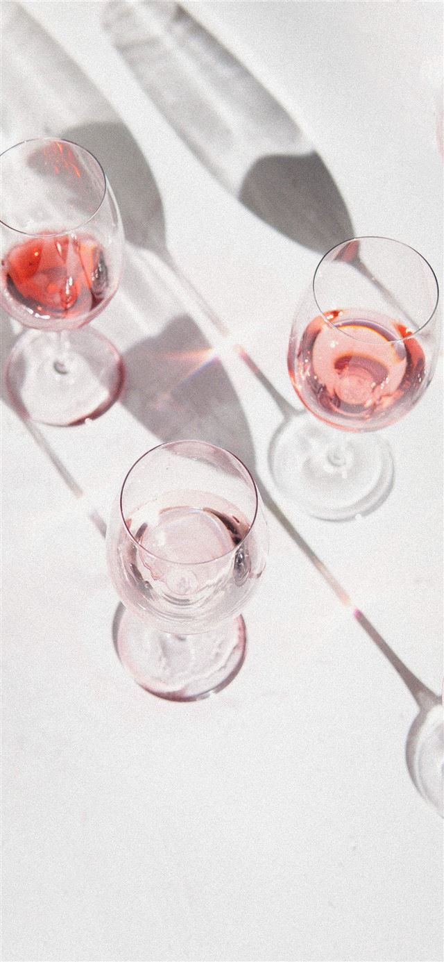clear wine glasses on white table iPhone 11 wallpaper 