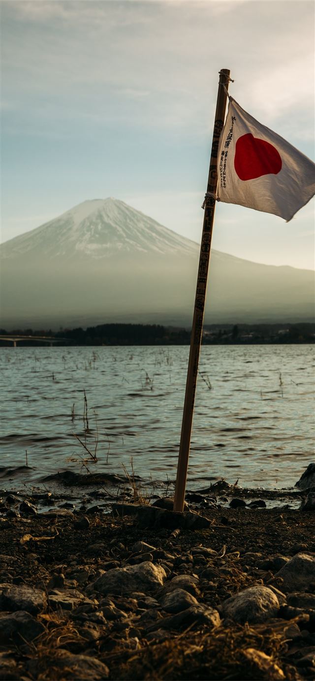 Japan flag mounted near on body of water iPhone 11 wallpaper 