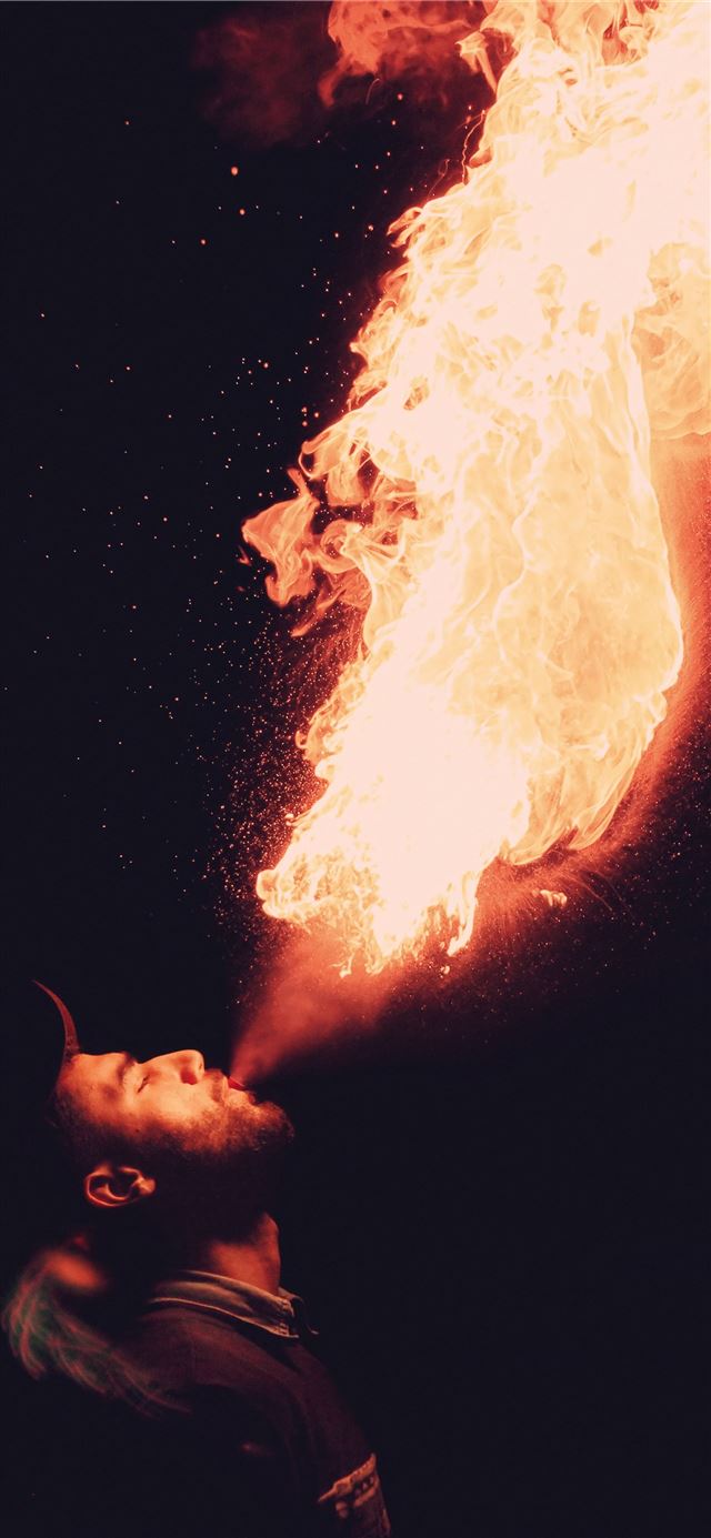man blowing fire iPhone 8 wallpaper 
