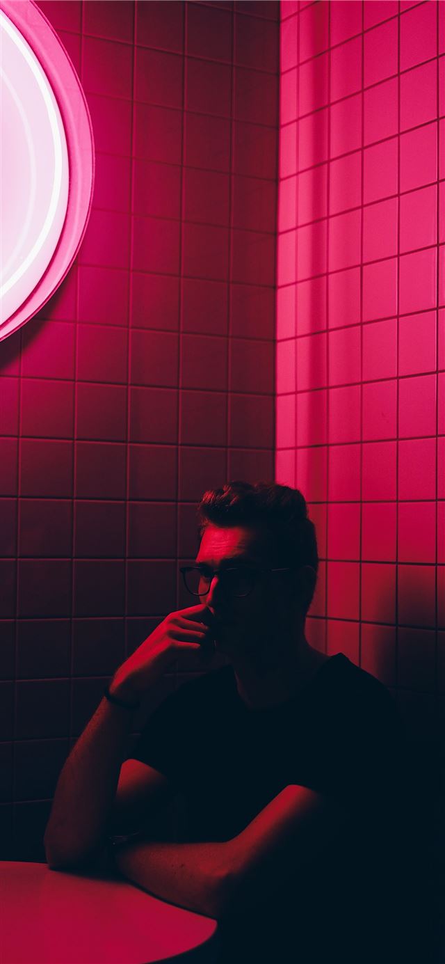 man sitting at the table inside dark room iPhone 11 wallpaper 
